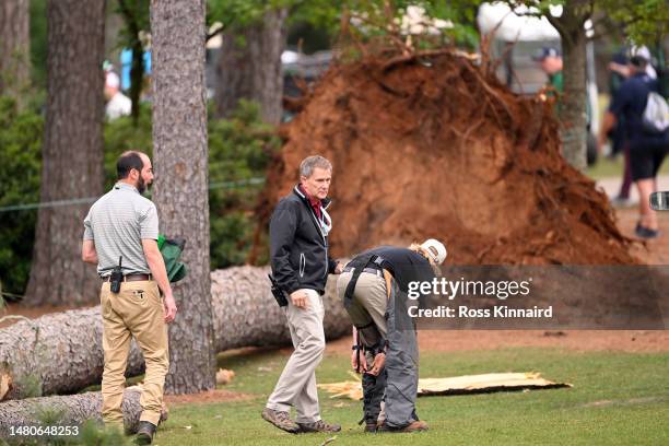 Course officials look over fallen trees on the 17th hole during the second round of the 2023 Masters Tournament at Augusta National Golf Club on...