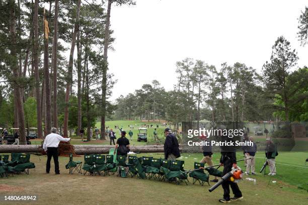 Course officials look over fallen trees on the 17th hole during the second round of the 2023 Masters Tournament at Augusta National Golf Club on...