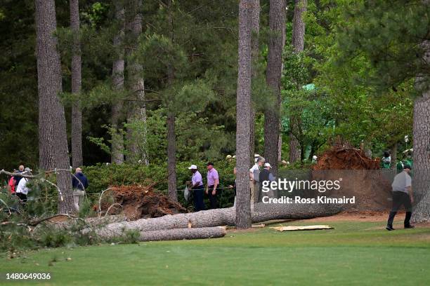 Course officials look over fallen trees on the 17th hole during the second round of the 2023 Masters Tournament at Augusta National Golf Club on...