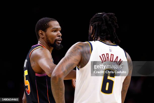 Kevin Durant of the Phoenix Suns talks to DeAndre Jordan of the Denver Nuggets during the second half at Footprint Center on April 06, 2023 in...
