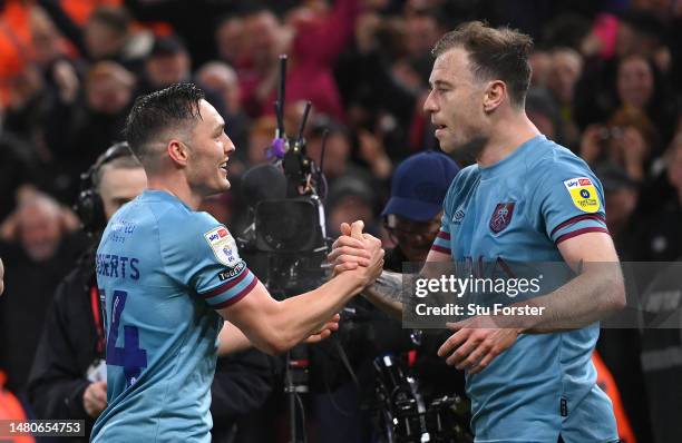 Burnley player Connor Roberts celebrates with Ashley Barnes after scoring the second Burnley goal during the Sky Bet Championship between...