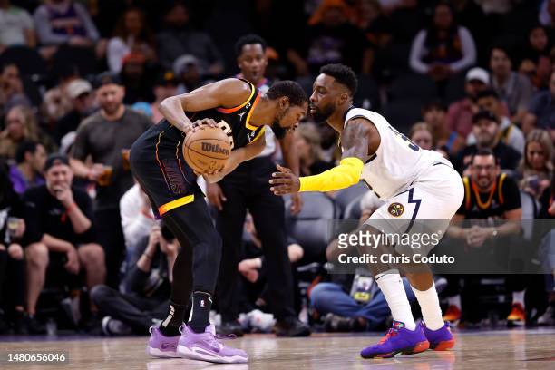 Jeff Green of the Denver Nuggets guards Kevin Durant of the Phoenix Suns during the game at Footprint Center on April 06, 2023 in Phoenix, Arizona....