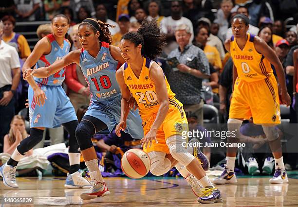 Kristi Toliver of the Los Angeles Sparks handles the ball against Lindsey Harding of the Atlanta Dream at Staples Center on July 8, 2012 in Los...