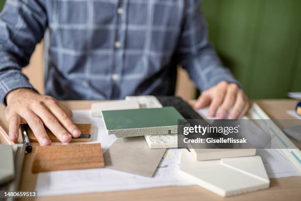 architect going over tile samples at his office desk - tile samples stock pictures, royalty-free photos & images