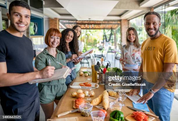 portrait of multiracial group of people in cooking class - stage set stockfoto's en -beelden