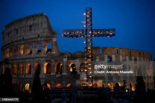 General view shows the lit up cross before the Via Crucis procession of Good Friday at the Colosseum , on April 7, 2023 in Rome, Italy. The Way of...