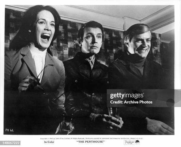 Martine Beswick, Tony Beckley, and Norman Rodway gathered together in a scene from the film 'The Penthouse', 1967.