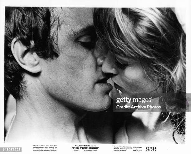 Suzy Kendall and man about to kiss in a scene from the film 'The Penthouse', 1967.