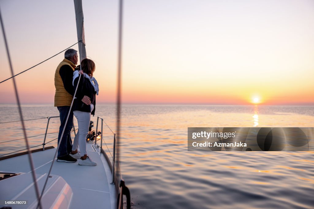 Beautiful Mature Couple Enjoying Cruising On The Sailing Boat