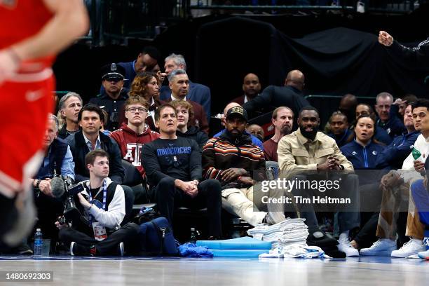 Dallas Mavericks owner Mark Cuban, Kyrie Irving and Tim Hardaway Jr. Sit court side during the game against the Chicago Bulls at American Airlines...
