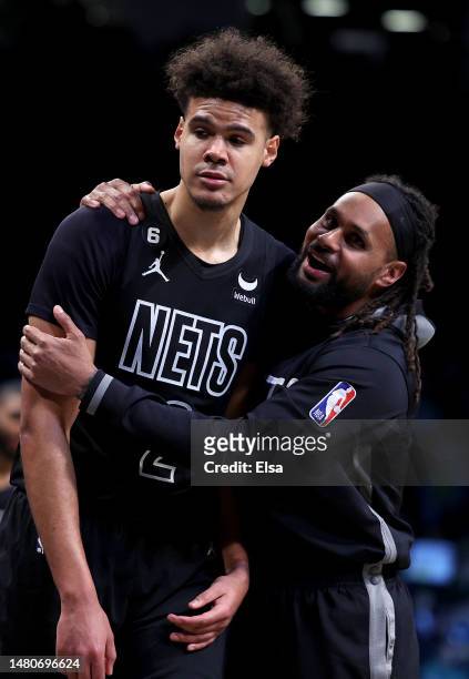 Cameron Johnson and Patty Mills of the Brooklyn Nets celebrate in the fourth quarter against the Orlando Magic at Barclays Center on April 07, 2023...