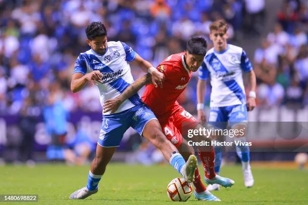 Diego de Buen of Puebla battles for possession with 4t during the 14th round match between Puebla and Toluca as part of the Torneo Clausura 2023 Liga...