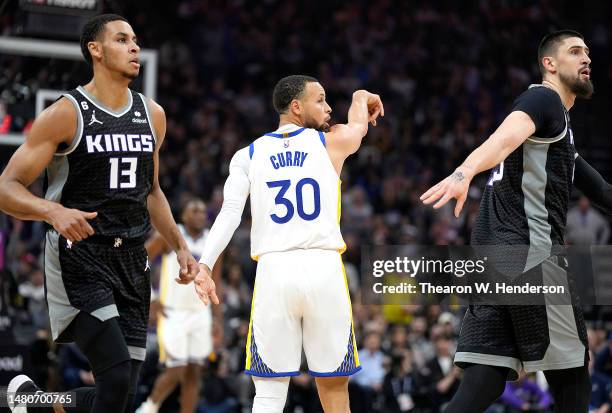 Stephen Curry of the Golden State Warriors reacts after shooting a three-point shot against the Sacramento Kings during the first quarter at Golden 1...