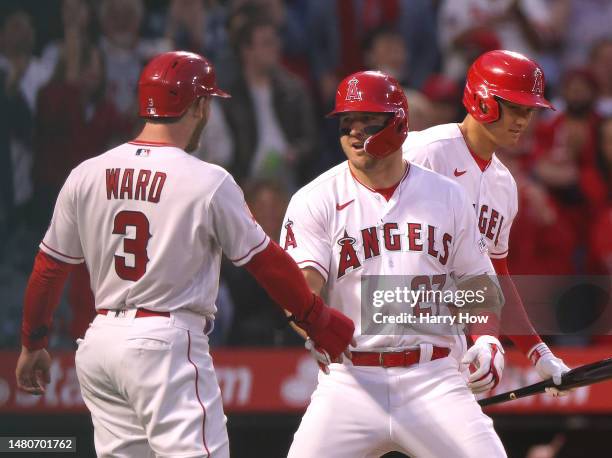 Mike Trout of the Los Angeles Angels celebrates his two run homerun with Taylor Ward and Shohei Ohtani, to take a 2-0 lead over the Toronto Blue...