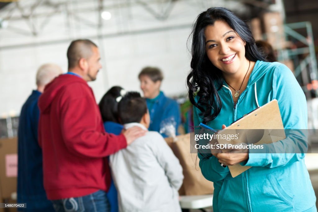 Young woman with clipboard at a donation relief center