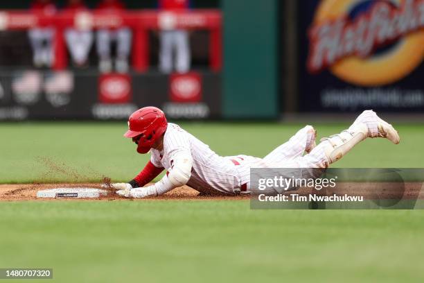 Nick Castellanos of the Philadelphia Phillies slides after hitting a double against the Cincinnati Reds at Citizens Bank Park on April 07, 2023 in...