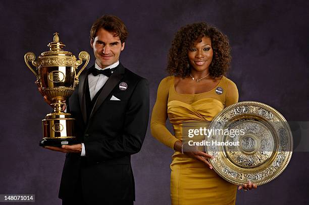 In this handout image supplied by the All England Lawn Tennis Club , Wimbledon Singles Champions Serena Williams of the USA and Roger Federer of...