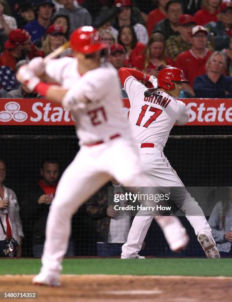 Shohei Ohtani of the Los Angeles Angels on deck behind Mike Trout during the eighth inning against the Toronto Blue Jays in the 2023 home opener at...