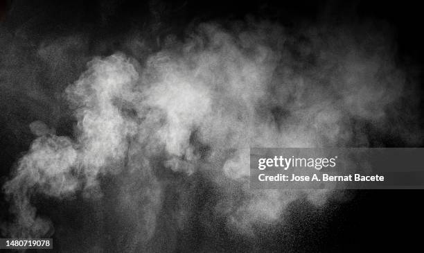 shock wave from an explosion of dust and smoke on a black background. - bangs stock pictures, royalty-free photos & images