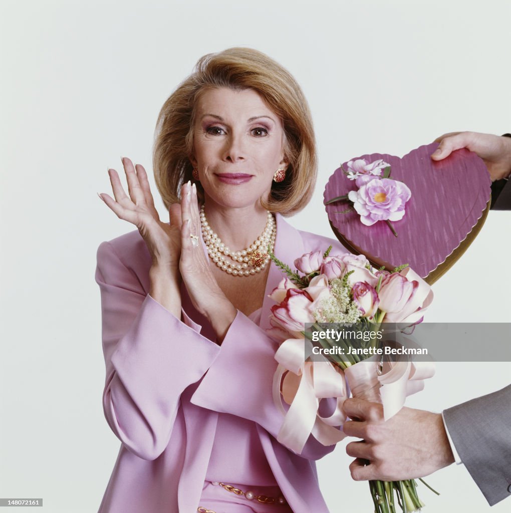 Joan Rivers Profile Portrait of American comedian Joan Rivers dressed in a pink suit as ...