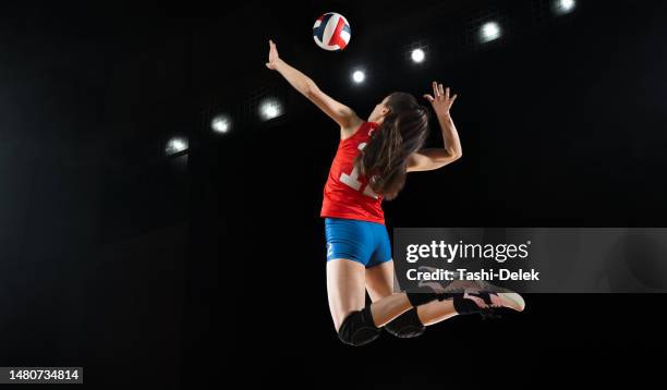 volleyball: female player in action - womens volleyball stock pictures, royalty-free photos & images