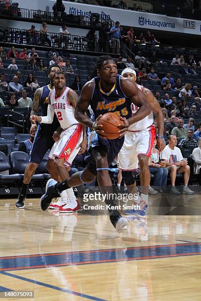 Kenneth Faried of the Denver Nuggets moves the ball against the Charlotte Bobcats during the game at the Time Warner Cable Arena on March 30, 2012 in...