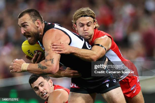 Charlie Dixon of Power is tackled by James Rowbottom of the Swans during the round four AFL match between Sydney Swans and Port Adelaide Power at...