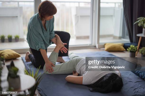 foot and leg shiatsu massager - woman lying on stomach with feet up stock pictures, royalty-free photos & images