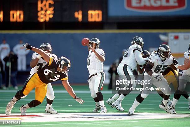 Quarterback Donovan McNabb of the Philadelphia Eagles passes while under pressure from defensive lineman Kimo von Oelhoffen of the Pittsburgh...