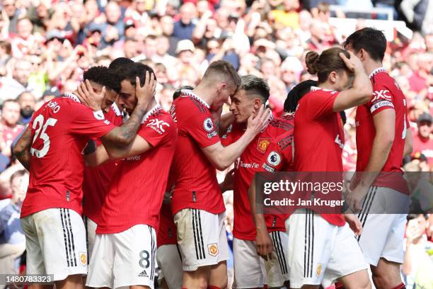 Scott McTominay of Manchester United celebrates with teammates after scoring the team's first goal during the Premier League match between Manchester...