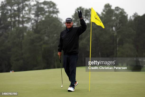 Sandy Lyle of Scotland acknowledges patrons on the 18th green during the continuation of the weather delayed second round of the 2023 Masters...