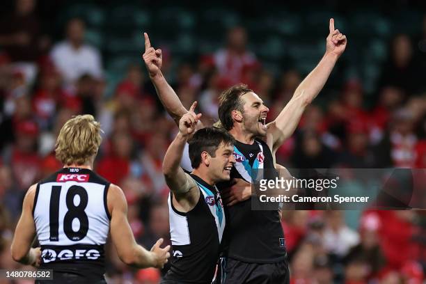 Jeremy Finlayson celebrates kicking a goal with team mates during the round four AFL match between Sydney Swans and Port Adelaide Power at Sydney...