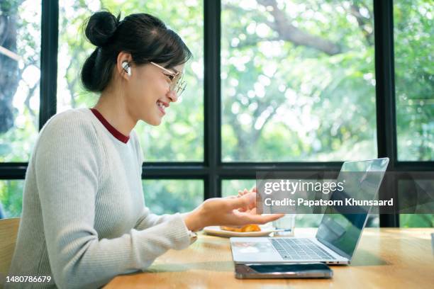 asian people using laptop and mobile phone. - zoom interview stock pictures, royalty-free photos & images