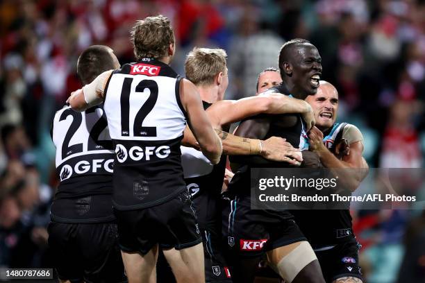 Aliir Aliir of Port Adelaide celebrates with team mates at full time during the round four AFL match between Sydney Swans and Port Adelaide Power at...