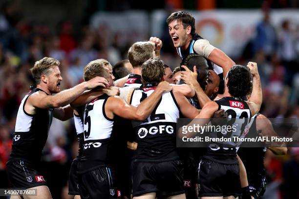 Aliir Aliir of Port Adelaide celebrates with team mates at full time during the round four AFL match between Sydney Swans and Port Adelaide Power at...