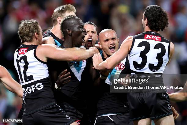 Aliir Aliir of Port Adelaide celebrates with team mates at full time during the round four AFL match between Sydney Swans and Port Adelaide Power at...