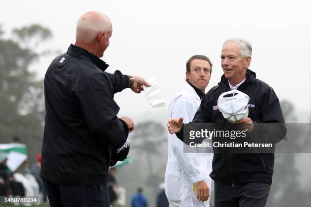 Larry Mize of the United States is greeted by Sandy Lyle of Scotland on the 18th green during the continuation of the weather delayed second round of...