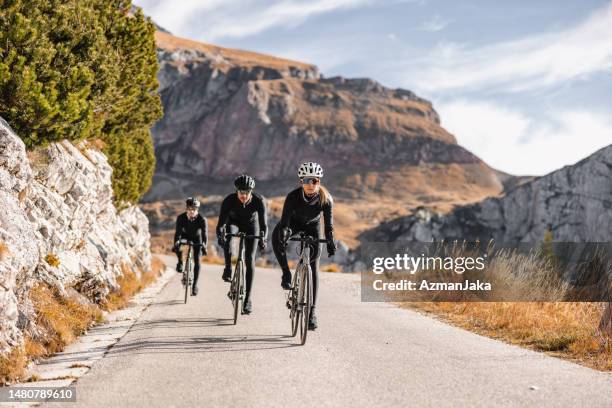 professional cyclists riding through nature - mid adult stock pictures, royalty-free photos & images