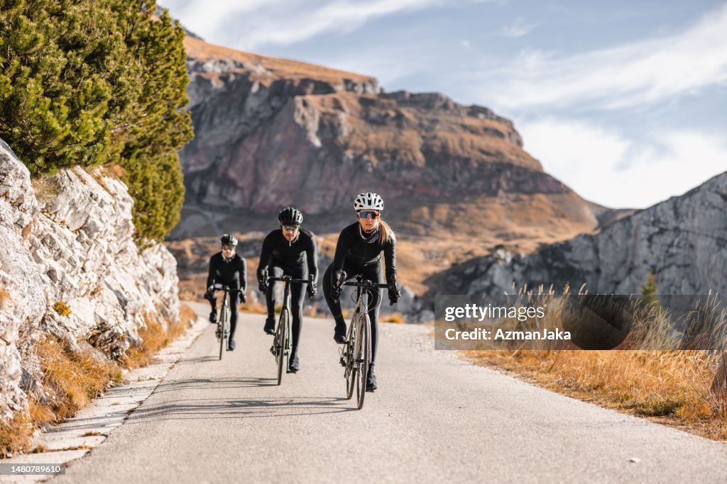 Professional Cyclists Riding Through Nature