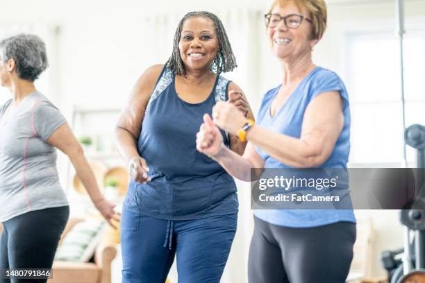 seniors dancing - zumba stock pictures, royalty-free photos & images