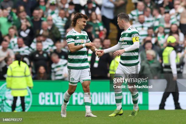 Jota of Celtic celebrates with teammate Callum McGregor after scoring the team's third goal during the Cinch Scottish Premiership match between...