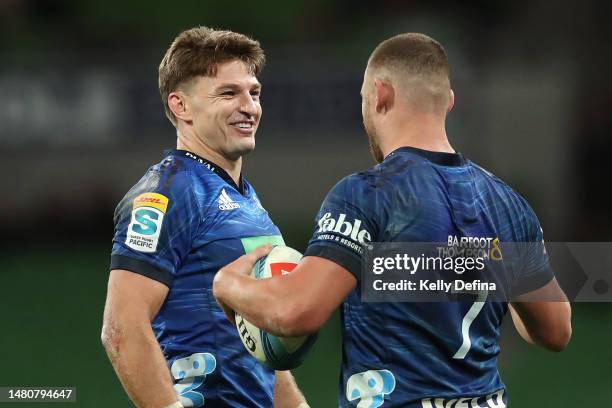 Beauden Barrett of the Blues celebrates with Dalton Papali'i of the Blues during the round seven Super Rugby Pacific match between Melbourne Rebels...