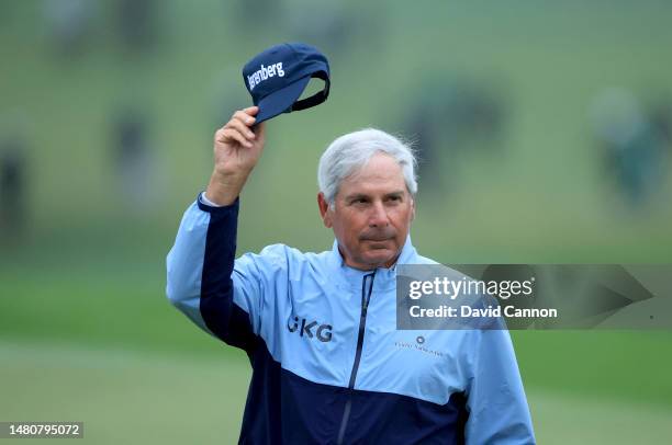 Fred Couples of The United States acknowledges the patrons as he walks off the 18th green having made the cut on one over par during the completion...