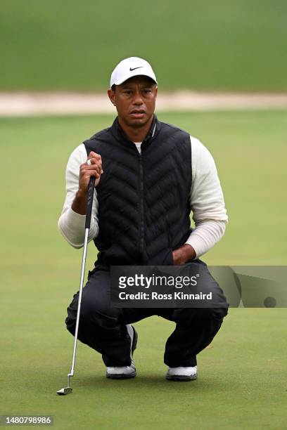 Tiger Woods of the United States looks over a putt on the 16th green during the continuation of the weather delayed second round of the 2023 Masters...