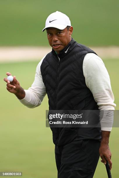 Tiger Woods of the United States reacts to his putt on the 16th green during the continuation of the weather delayed second round of the 2023 Masters...