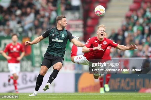Niclas Fuellkrug of SV Werder Bremen clashes with Andreas Hanche-Olsen of 1.FSV Mainz 05 during the Bundesliga match between 1. FSV Mainz 05 and SV...