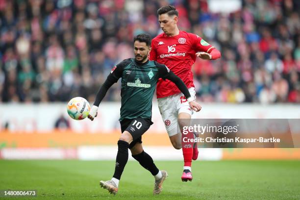 Leonardo Bittencourt of SV Werder Bremen is put under pressure by Anthony Caci of 1.FSV Mainz 05 during the Bundesliga match between 1. FSV Mainz 05...