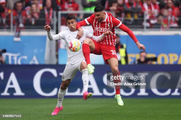 Joao Cancelo of Bayern Munich battles for possession with Vincenzo Grifo of SC Freiburg during the Bundesliga match between Sport-Club Freiburg and...