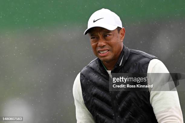 Tiger Woods of the United States looks on from the 18th green during the continuation of the weather delayed second round of the 2023 Masters...