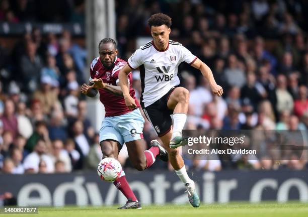Issa Diop of Fulham is challenged by Michail Antonio of West Ham United during the Premier League match between Fulham FC and West Ham United at...